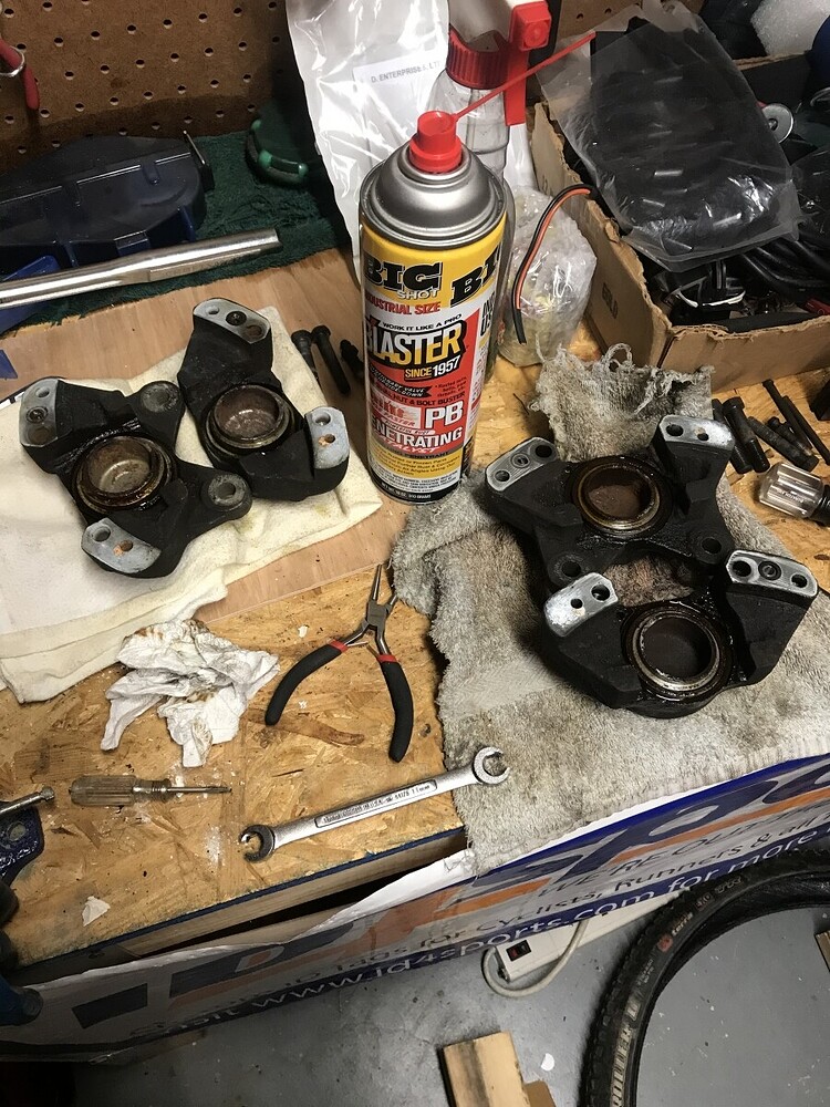 Engine parts and carburetor cleaner spray on workbench